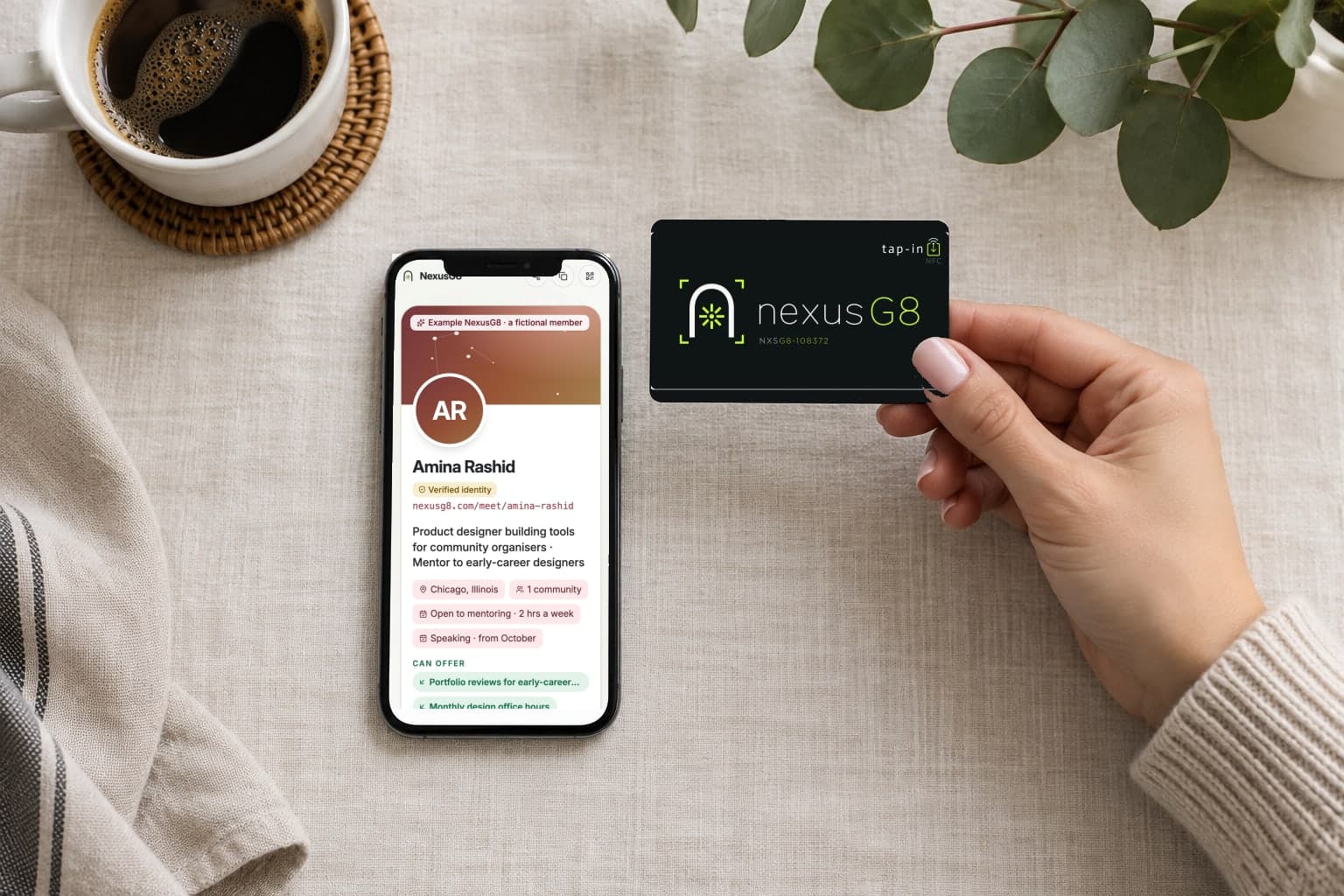 A matte black NexusG8 card held beside a phone showing the page it opens